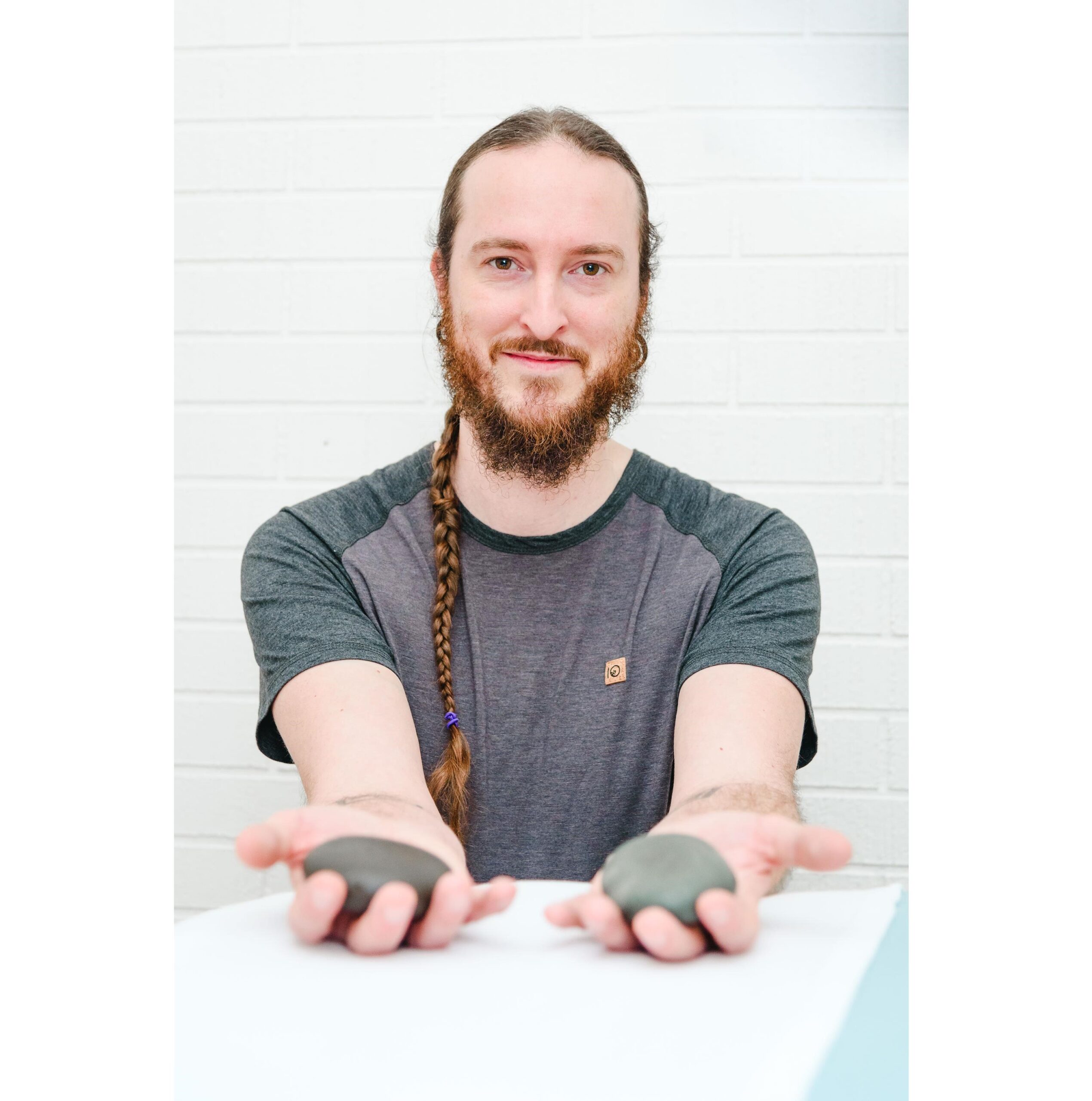Jon Dawson RMT holding hot stones used in registered massage therapy